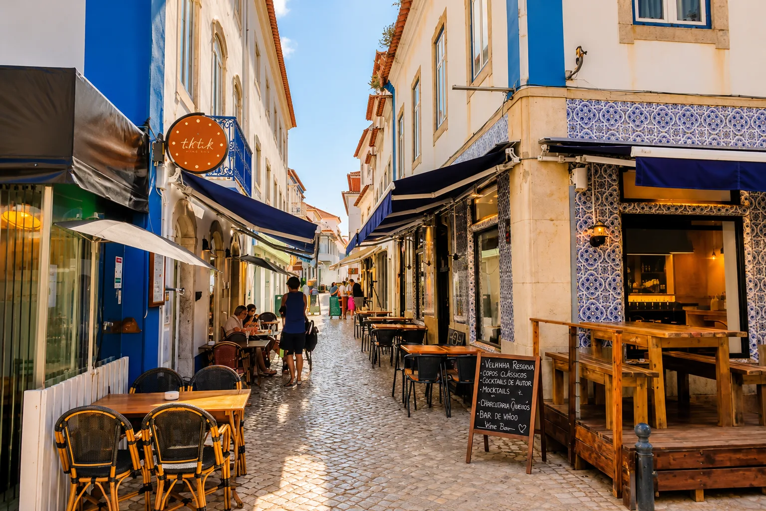 Cobbled street with tiled wine bars in Ericeira
